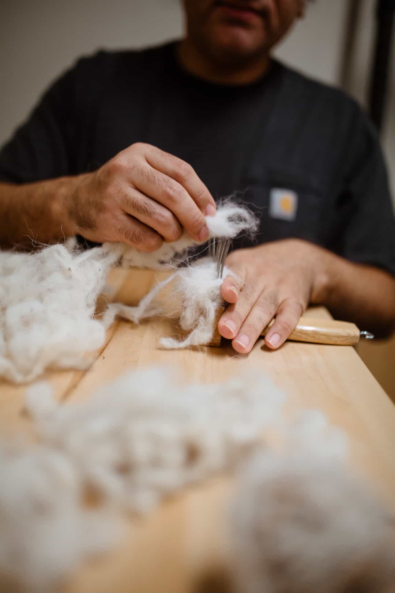 Artist working with wool fiber
